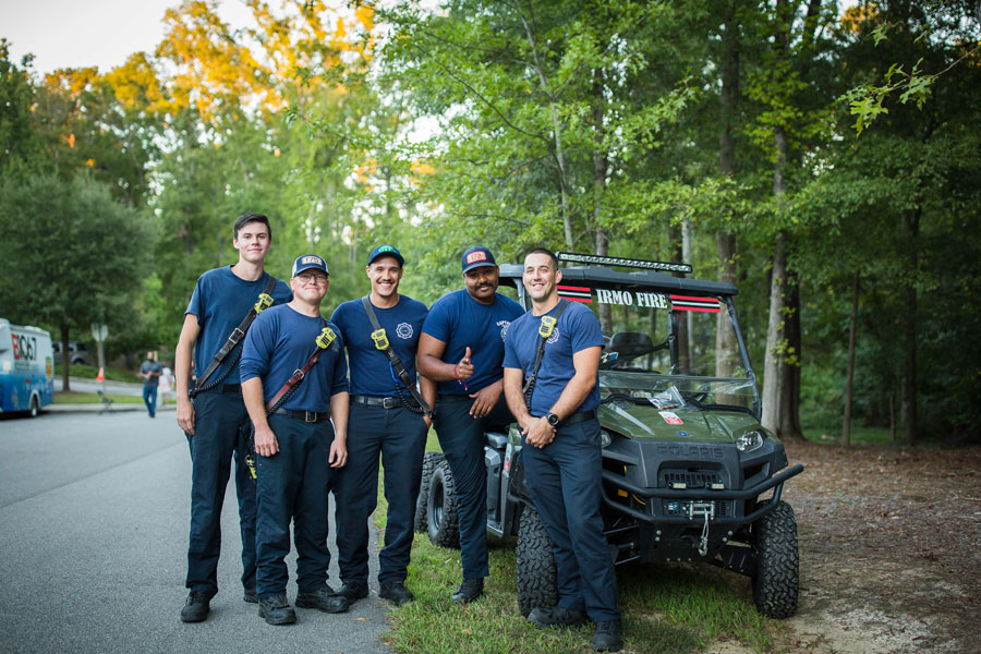 Fire Fighters stand in front of atv