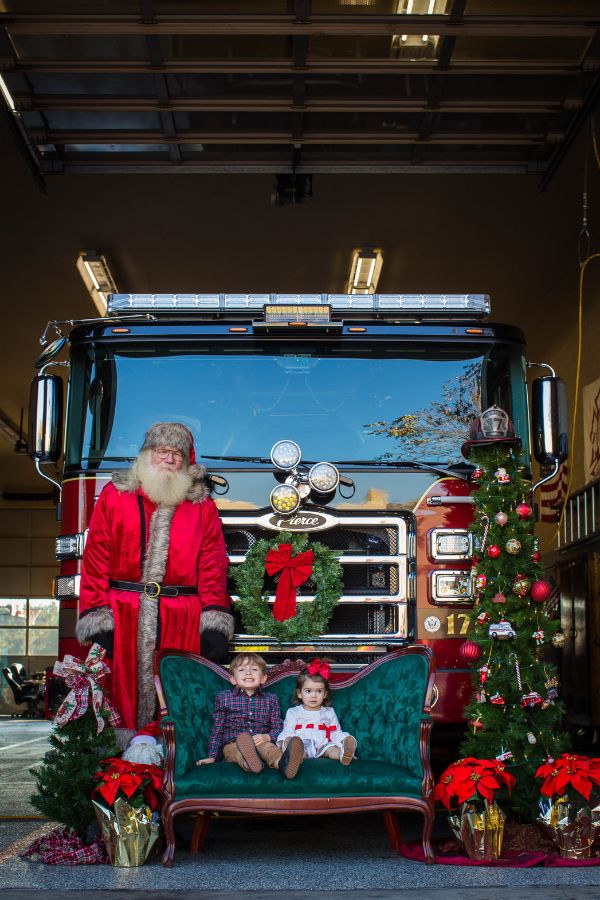 Brothers with Santa in front of Fire Engine.